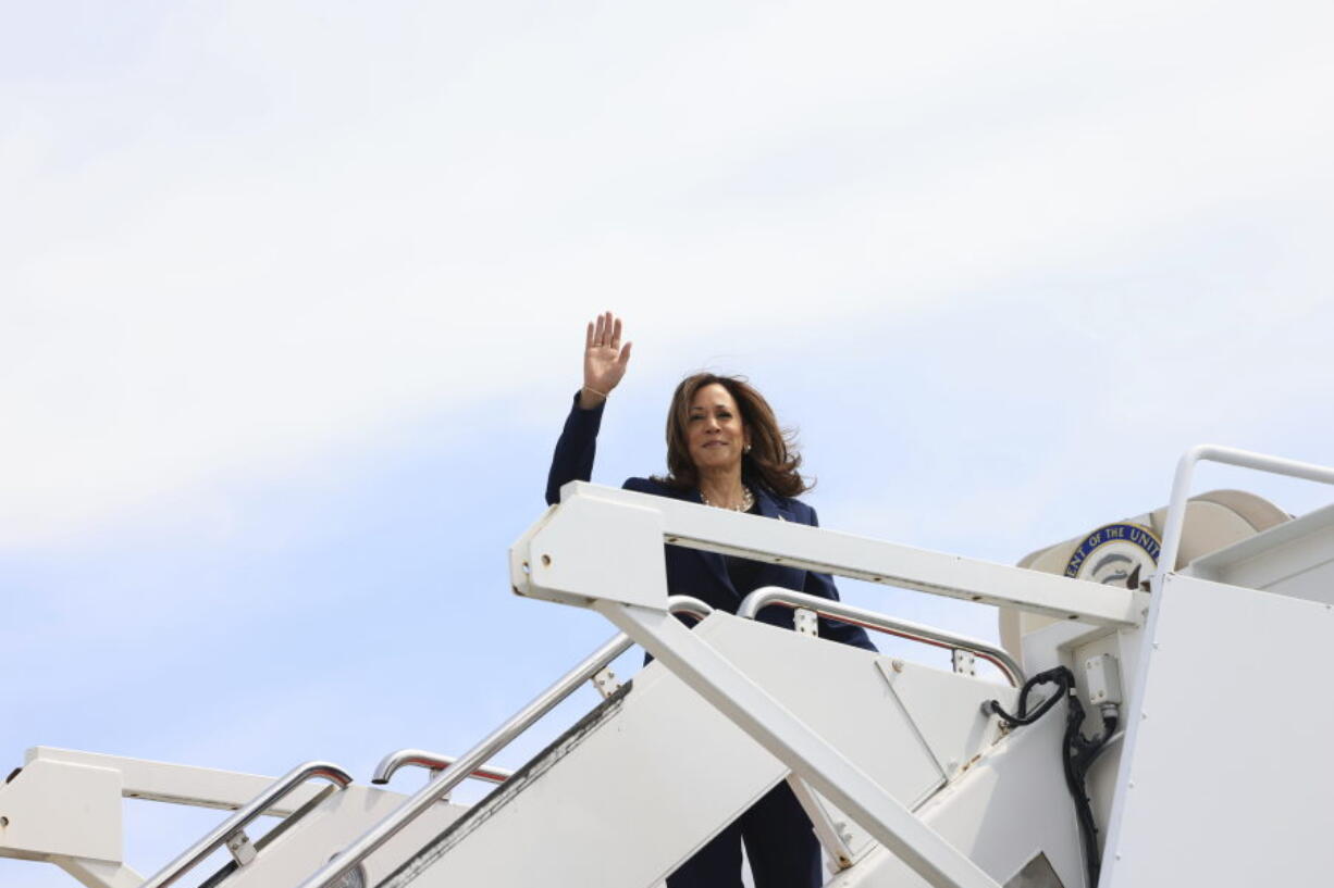 Vice President Kamala Harris waves while boarding Air Force Two as she departs on campaign travel to Milwaukee, Wisc., Tuesday, July 23, 2024 at Andrews Air Force Base, Md.