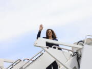 Vice President Kamala Harris waves while boarding Air Force Two as she departs on campaign travel to Milwaukee, Wisc., Tuesday, July 23, 2024 at Andrews Air Force Base, Md.