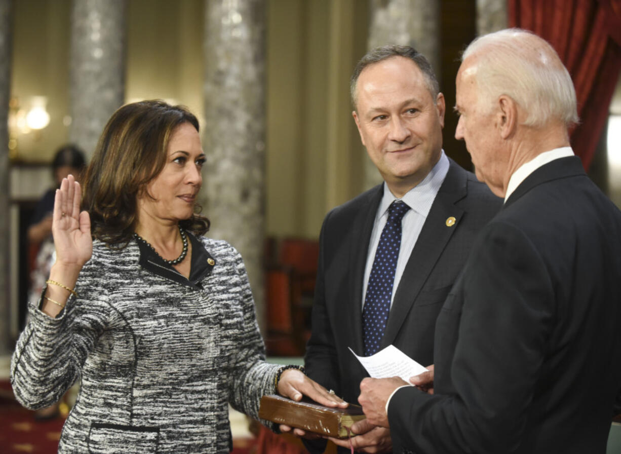 FILE - Vice President Joe Biden administers the Senate oath of office to Sen. Kamala Harris, D-Calif., as her husband, Douglas Emhoff, holds the Bible during a a mock swearing in ceremony in the Old Senate Chamber on Capitol Hill in Washington, Jan. 3, 2017, as the 115th Congress begins. She&rsquo;s already broken barriers, and now Vice President Harris could soon become the first Black woman to head a major party&rsquo;s presidential ticket after President Joe Biden&rsquo;s ended his reelection bid. The 59-year-old Harris was endorsed by Biden on Sunday, July 21, after he stepped aside amid widespread concerns about the viability of his candidacy.