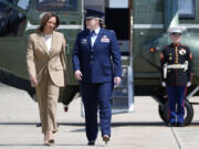 Vice President Kamala Harris, left, arrives to board Air Force Two at Andrews Air Force Base in Md., Saturday, July 27, 2024. Harris is traveling to Pittsfield, Mass., to participate in a political event.