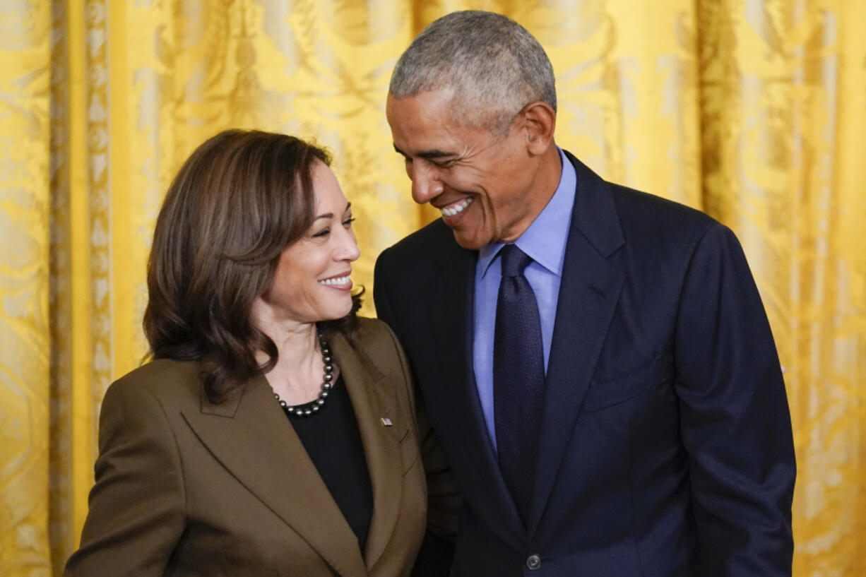 FILE - Former President Barack Obama talks with Vice President Kamala Harris during an event about the Affordable Care Act, in the East Room of the White House in Washington, April 5, 2022. Former President Barack Obama and former first lady Michelle Obama have endorsed Kamala Harris in her White House bid, giving the vice president the expected but still crucial backing of the nation&rsquo;s two most popular Democrats.