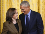 FILE - Former President Barack Obama talks with Vice President Kamala Harris during an event about the Affordable Care Act, in the East Room of the White House in Washington, April 5, 2022. Former President Barack Obama and former first lady Michelle Obama have endorsed Kamala Harris in her White House bid, giving the vice president the expected but still crucial backing of the nation&rsquo;s two most popular Democrats.