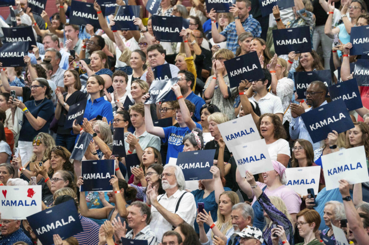 FILE - Supports hold up signs in support of Vice President Kamala Harris at an event, July 23, 2024, in West Allis, Wis. Voters, especially those who lean left, are expressing a renewed interest in the campaign and eager to see Harris take on the Democratic Party mantle in place of President Joe Biden. Harris&rsquo; campaign is trying to capitalize on a jolt of fundraising, volunteer interest and media attention after Democrats spent three weeks following Biden&rsquo;s debate debacle wondering whether the octogenarian president would stand down or continue his campaign  despite dwindling support.