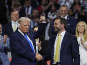 Republican presidential candidate former President Donald Trump is introduced during the Republican National Convention Tuesday, July 16, 2024, in Milwaukee. At right is Republican vice presidential candidate Sen. JD Vance, R-Ohio.