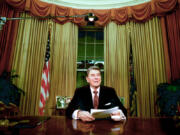 FILE - President Ronald Reagan sits in the Oval Office after he delivered his farewell address to the nation Jan. 11, 1989, from the Oval Office of the White House in Washington. The age question for presidential candidates is more than four decades old.