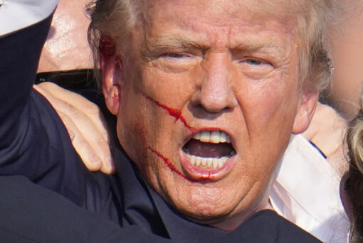 Republican presidential candidate former President Donald Trump reacts following an assassination attempt at a campaign event in Butler, Pa., on Saturday, July 13, 2024. (AP Photo/Gene J.