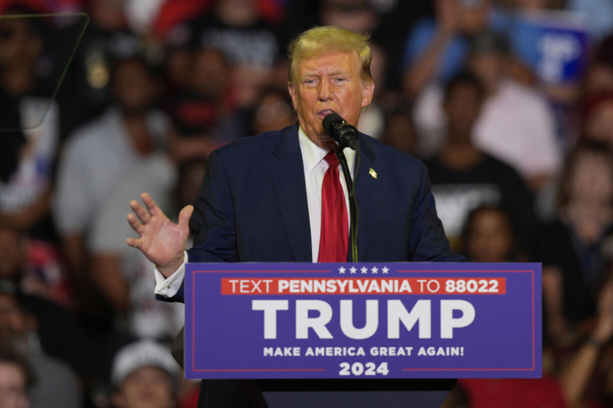 FILE - Republican presidential candidate former President Donald Trump speaks at a campaign rally, June 22, 2024, in Philadelphia. Trump is seeking to distance himself from a plan for a massive overhaul of the federal government drafted by some of his administration officials. Some of these men are expected to take high-level roles if the Republican presumptive nominee is elected back into the White House.