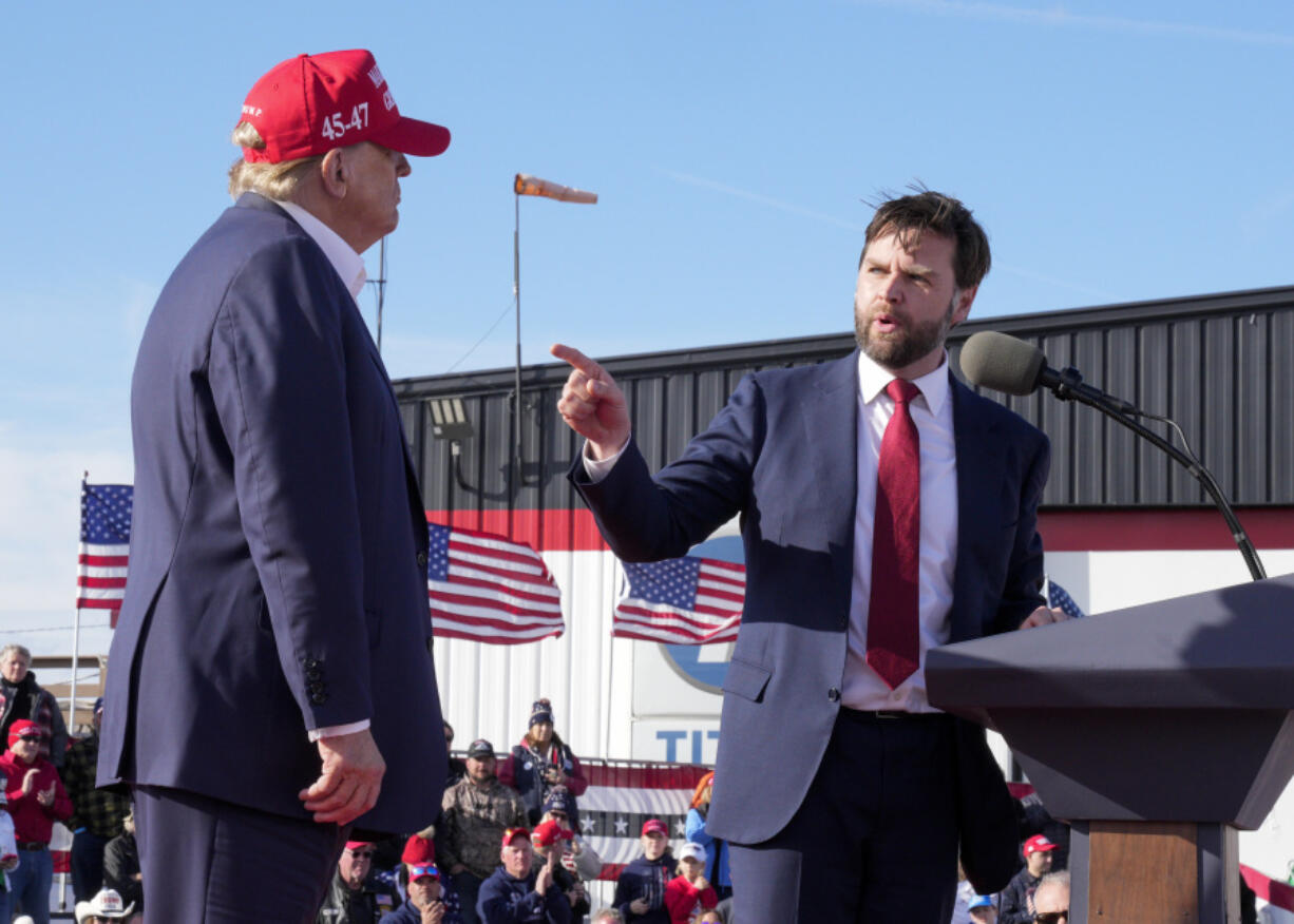 FILE - Sen. J.D. Vance, R-Ohio, right, points toward Republican presidential candidate former President Donald Trump at a campaign rally on March 16, 2024, in Vandalia, Ohio. Vance sharply criticized Trump during the 2016 election cycle, before changing course and embracing the former president. Vance is now one of Trump&rsquo;s fiercest allies and defenders and among those short-listed to be Trump&rsquo;s vice presidential pick.