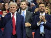 FILE - Republican presidential candidate former President Donald Trump, left, and Republican vice presidential candidate Sen. JD Vance, R-Ohio, attend the Republican National Convention, July 15, 2024, in Milwaukee. Vice President Kamala Harris and her Democratic allies are increasingly branding Trump and Vance as &ldquo;weird.&rdquo; Democrats are applying the label with gusto in interviews and online.