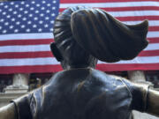 FILE - The Fearless Girl statues faces the New York Stock Exchange on July 2, 2024, in New York. Global stocks are mixed on Friday, July 12, 2024, with the Japanese yen losing some of its gains after the latest U.S. update on inflation bolstered Wall Street&rsquo;s belief that relief on interest rates may come as soon as September.