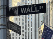 A sign at the intersection of Broad Street and Wall Street is shown on Tuesday, July 16, 2024, in New York. Wall Street is logging tiny gains early as earnings season revs up ahead of the release of U.S. retail sales data that could influence a decision by the Federal Reserve on interest rates.