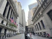 The New York Stock Exchange, left, is shown on Wednesday, July 10, 2024, in New York.