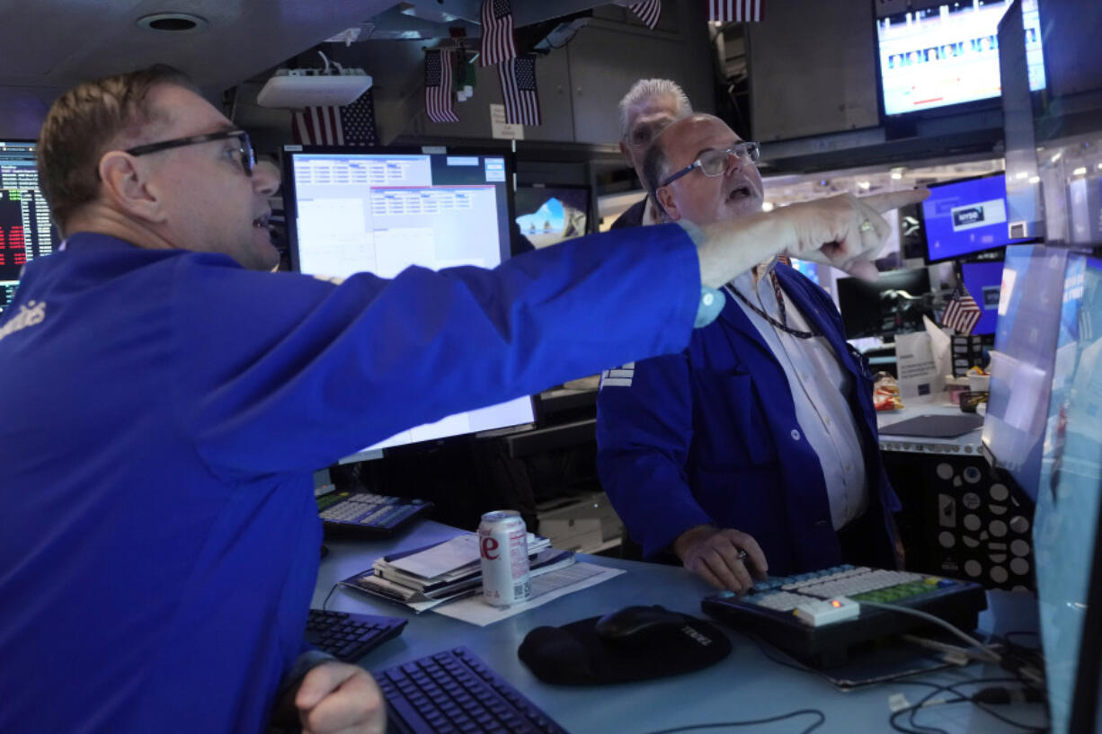 Specialists Patrick King, left, and Douglas Johnson work on the floor of the New York Stock Exchange, Monday, July 22, 2024. U.S. stocks are climbing Monday and clawing back some of the losses from their worst week since April.