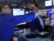 Specialists Patrick King, left, and Douglas Johnson work on the floor of the New York Stock Exchange, Monday, July 22, 2024. U.S. stocks are climbing Monday and clawing back some of the losses from their worst week since April.