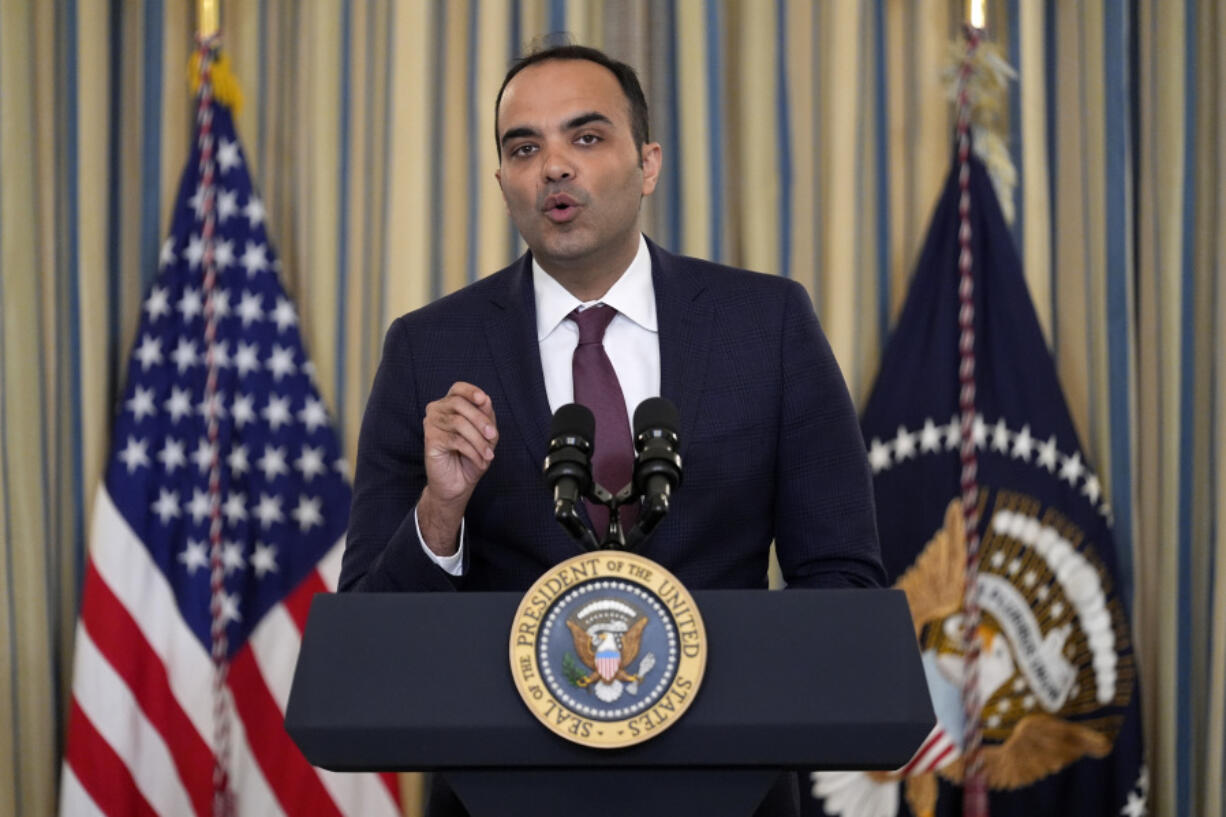 FILE - Rohit Chopra, director of the Consumer Financial Protection Bureau, speaks as President Joe Biden meets with his Competition Council to announce new actions to lower costs for families in the State Dining Room of the White House in Washington, on March 5, 2024. The CFPB said Thursday July 18, 2024 that apps that allow workers to access their paychecks in advance, often for a fee, are providing loans and should be subject to the Truth in Lending Act.