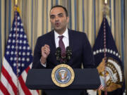 FILE - Rohit Chopra, director of the Consumer Financial Protection Bureau, speaks as President Joe Biden meets with his Competition Council to announce new actions to lower costs for families in the State Dining Room of the White House in Washington, on March 5, 2024. The CFPB said Thursday July 18, 2024 that apps that allow workers to access their paychecks in advance, often for a fee, are providing loans and should be subject to the Truth in Lending Act.