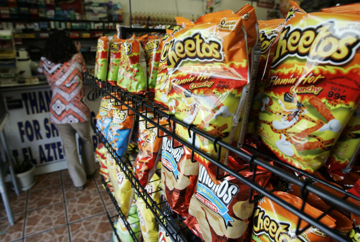 FILE - Flamin&rsquo; Hot Cheetos are pictured near the front door of La Azteca Market in South Los Angeles, Aug. 22, 2008. The man who says he invented Flamin&rsquo; Hot Cheetos filed a lawsuit against his former employers Thursday, July 18, 2024, for fraud, defamation and other violations, saying he was harmed when Frito-Lay and PepsiCo denied his role in creating the popular hot snack.