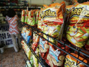 FILE - Flamin&rsquo; Hot Cheetos are pictured near the front door of La Azteca Market in South Los Angeles, Aug. 22, 2008. The man who says he invented Flamin&rsquo; Hot Cheetos filed a lawsuit against his former employers Thursday, July 18, 2024, for fraud, defamation and other violations, saying he was harmed when Frito-Lay and PepsiCo denied his role in creating the popular hot snack.