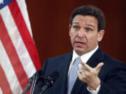 FILE - Florida Gov. Ron DeSantis answers questions from the media, March 7, 2023, at the state Capitol in Tallahassee, Fla. DeSantis spent more than an hour talking about what is in the $116.5 billion he signed Wednesday, June 12, 2024, but he left out the most important part of the announcement: What was in the nearly $1 billion he vetoed.