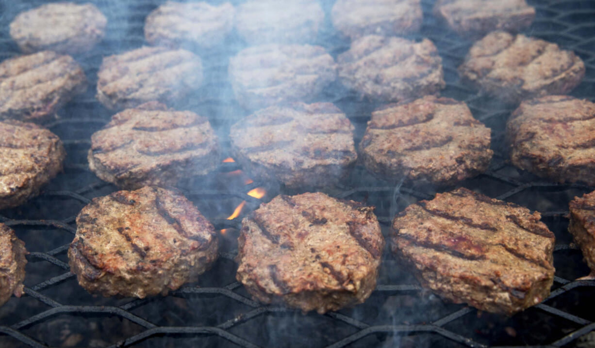 Smoke wafts up as hamburgers are cooked on a grill outside. Most grillers recommend a mixture of 80 percent beef to 20 percent fat, but Craig &ldquo;Meathead&rdquo; Goldwyn, author of &ldquo;Meathead, The Science of Great Barbecue and Grilling,&rdquo; prefers even more fat, up to a 70:30 ratio.