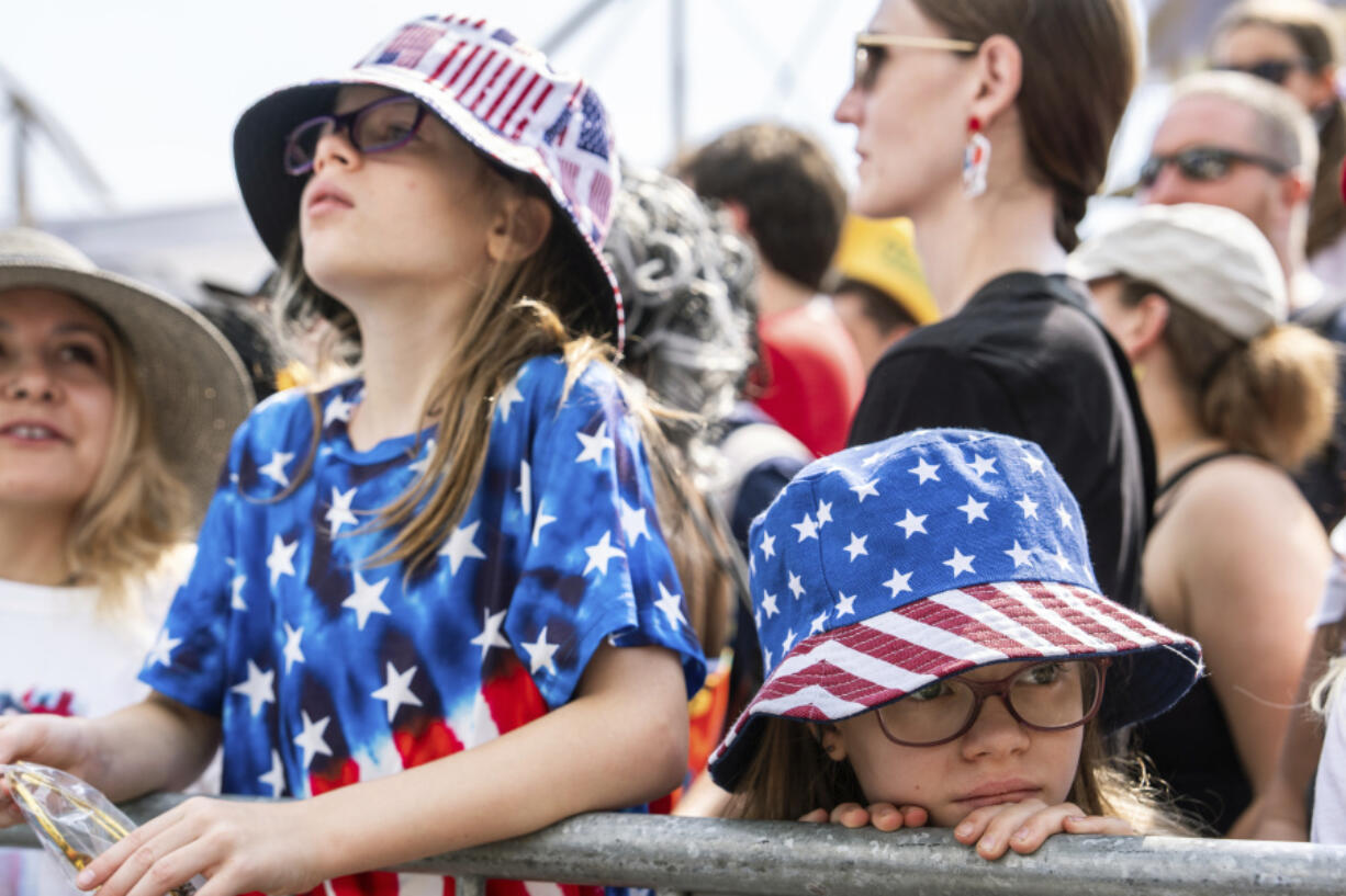 People wait for the Nathan&rsquo;s Famous Fourth of July hot dog eating contest to start, Thursday, July 4, 2024 at Coney Island in the Brooklyn borough of New York.