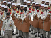 Troops of the Foreign Legion parade during the Bastille Day parade, Sunday, July 14, 2024 in Paris. The Olympic flame is lighting up the city&rsquo;s grandiose Bastille Day military parade. It&rsquo;s 12 days before the French capital hosts exceptionally ambitious and high-security Summer Games.