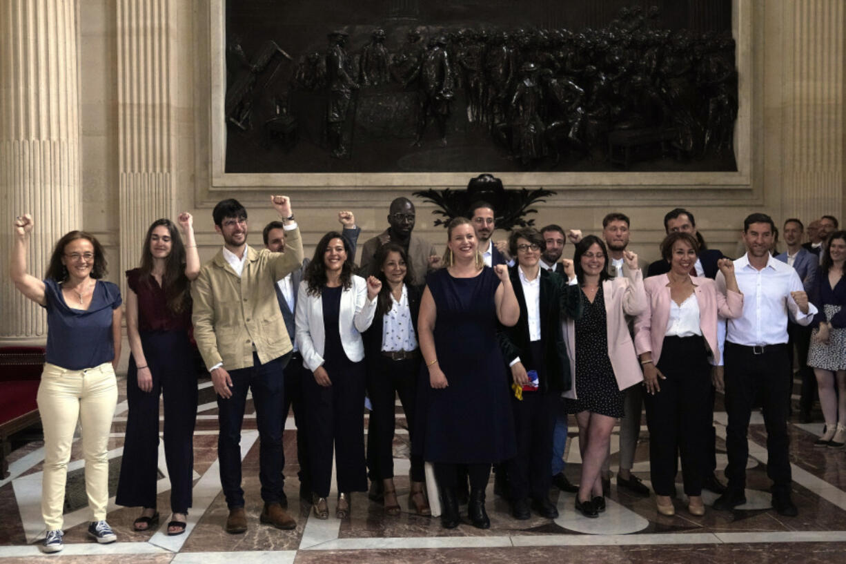 The group of elected parliament members of the far-left La France Insoumise (France Unbowed) party clench their fist inside the National Assembly, Tuesday, July 9, 2024 in Paris. French voters have given a broad leftist coalition the most parliamentary seats in a pivotal legislative election that has kept the far right from power but has put France in the unprecedented position of having no dominant political bloc in parliament.