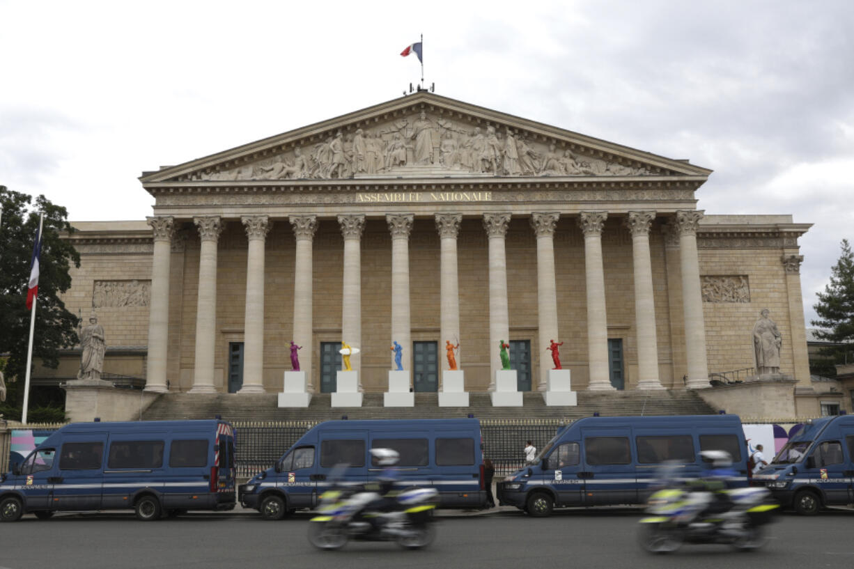 Police vans park outside the National Assembly during the second round of the legislative elections, Sunday, July 7, 2024 in Paris. France votes Sunday in pivotal runoff elections that could hand a historic victory to Marine Le Pen&rsquo;s far-right National Rally and its inward-looking, anti-immigrant vision &mdash; or produce a hung parliament and years of political deadlock.