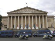 Police vans park outside the National Assembly during the second round of the legislative elections, Sunday, July 7, 2024 in Paris. France votes Sunday in pivotal runoff elections that could hand a historic victory to Marine Le Pen&rsquo;s far-right National Rally and its inward-looking, anti-immigrant vision &mdash; or produce a hung parliament and years of political deadlock.