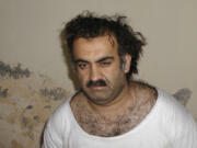 FILE- Khalid Sheikh Mohammed, the alleged Sept. 11 mastermind, is seen shortly after his capture during a raid in Pakistan Saturday March 1, 2003 in this photo obtained by the Associated Press. The man accused of being the main plotter in al-Qaeda&#039;s Sept. 11, 2001 attacks has agreed to plead guilty, The Defense Department said Wednesday.