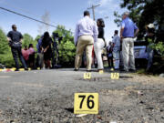 FILE - Bullet casings litter the ground behind a press conference on July 5, 2023, in Shreveport, La. At least three people were killed and 10 others wounded in the shooting. Violence and mass shootings often surge in the summer months, especially around the Fourth of July, historically one of the deadliest days each year.