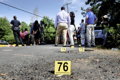 FILE - Bullet casings litter the ground behind a press conference on July 5, 2023, in Shreveport, La. At least three people were killed and 10 others wounded in the shooting. Violence and mass shootings often surge in the summer months, especially around the Fourth of July, historically one of the deadliest days each year.