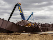 Twisted girders and debris cover the ground the day after a deadly structure collapse at a construction site near the Boise Airport, Feb. 1, 2024, in Boise, Idaho. On Tuesday, July 9, the families of two construction workers killed when the airport hangar collapsed filed suit against several companies that were involved in the building process, alleging the businesses recklessly cut corners and used inappropriate materials for the build.