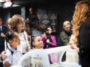 Vice President Kamala Harris, attends the opening of a pop-up ice cream shop owned by Tyra Banks, right, in Washington, Friday, July 19, 2024.