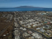 FILE - A general view shows the aftermath of a wildfire in Lahaina, Hawaii, Aug. 17, 2023. Hawaii Gov. Josh Green told the Associated Press on Wednesday, July 31, that the parties in Lahaina wildfire lawsuits against the state, Maui County and utilities are close to a global settlement of claims that will be worth a little over $4 billion. (AP Photo/Jae C.