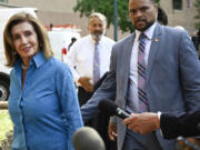 Rep. Nancy Pelosi, D-Calif., the speaker emerita, left, arrives at the Democratic National Headquarters with other Democratic members of the House of Representatives to discuss the future of President Biden running for the presidency, Tuesday, July 9, 2024 in Washington.