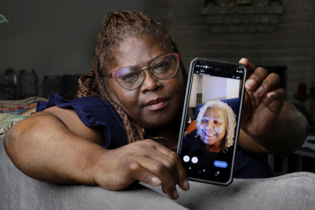 Janet Jarrett shows a photo of her sister, Pamela Jarrett, she keeps on her phone at the home they shared Friday, July 19, 2024, in Spring, Texas. Pamela Jarrett passed away after suffering heat related distress due to the power outage caused by hurricane Beryl.