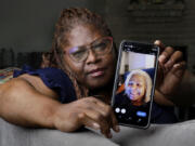 Janet Jarrett shows a photo of her sister, Pamela Jarrett, she keeps on her phone at the home they shared Friday, July 19, 2024, in Spring, Texas. Pamela Jarrett passed away after suffering heat related distress due to the power outage caused by hurricane Beryl.