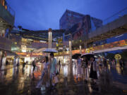 FILE - People shop at Taikoo Li Sanlitun shopping center in Beijing, China, on July 2, 2024. On Tuesday, July 16, 2024, the International Monetary Fund issues an update to its World Economic Outlook, a forecast for the global economy and major nations.