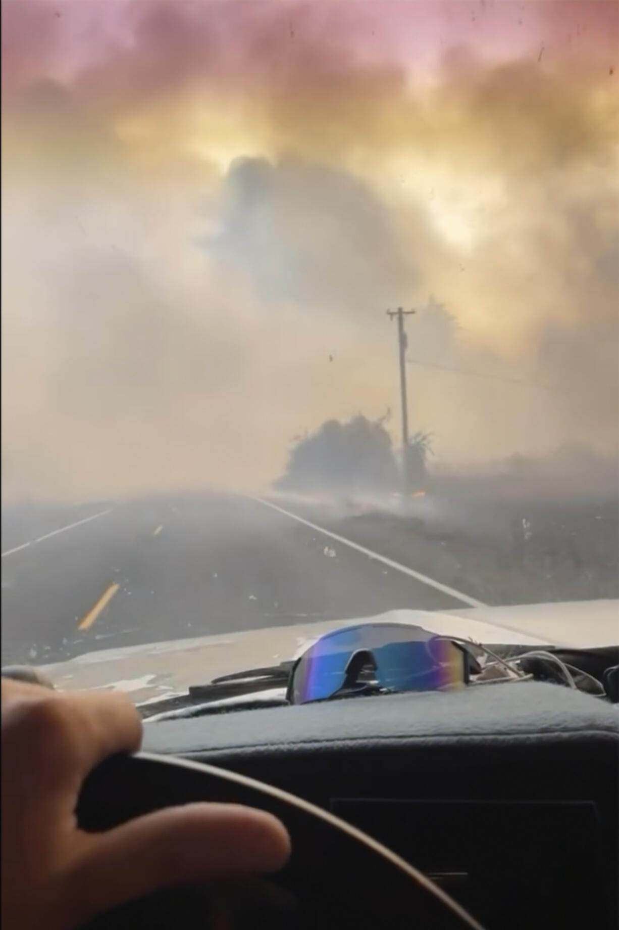 A motorist drives past the Gwen Fire on Highway 3 outside of Juliaetta, Idaho, on Thursday.