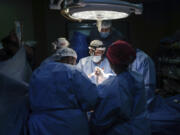 FILE - Doctors perform surgery on a patient at Al-Aqsa Martyrs Hospital, in Deir al-Balah, central Gaza, on March 17, 2024.