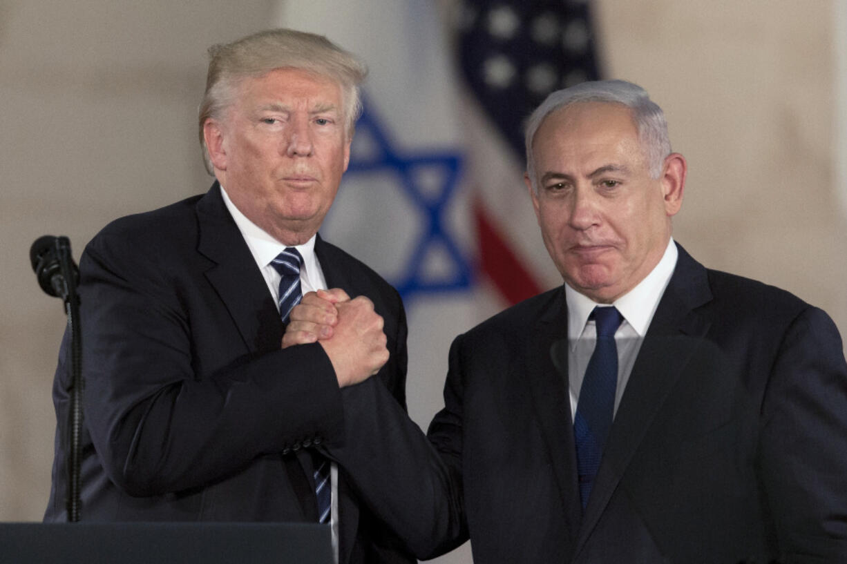 FILE - In this Tuesday, May 23, 2017, file photo, Israeli Prime Minister Benjamin Netanyahu, right, and US President Donald Trump shake hands at the Israel Museum in Jerusalem.