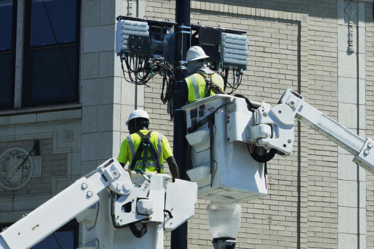 FILE - A utility crew works at a site in Chicago on June 27, 2024. On Tuesday, July 30, 2024, the Labor Department reports on job openings and labor turnover for June. (AP Photo/Nam Y.