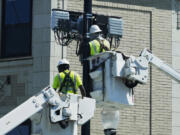 FILE - A utility crew works at a site in Chicago on June 27, 2024. On Tuesday, July 30, 2024, the Labor Department reports on job openings and labor turnover for June. (AP Photo/Nam Y.