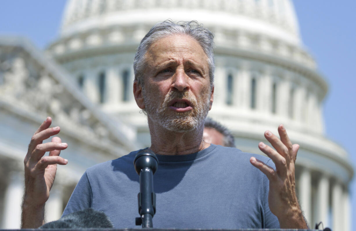 FILE - Entertainer and activist Jon Stewart speaks at the Capitol in Washington, May 26, 2021. Stewart is pressing the Biden administration to fix a loophole in a massive veterans aid bill that has left out some of the very first troops who responded after the Sept. 11 attacks. They got sick from staying at at Karshi-Khanabad, Uzbekistan, or K2, a base contaminated with enriched uranium. (AP Photo/J.