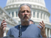 FILE - Entertainer and activist Jon Stewart speaks at the Capitol in Washington, May 26, 2021. Stewart is pressing the Biden administration to fix a loophole in a massive veterans aid bill that has left out some of the very first troops who responded after the Sept. 11 attacks. They got sick from staying at at Karshi-Khanabad, Uzbekistan, or K2, a base contaminated with enriched uranium. (AP Photo/J.