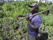 Benson Wanjala talks about the health of his soil at his farm in Machakos, Kenya, Tuesday, May 21, 2024.