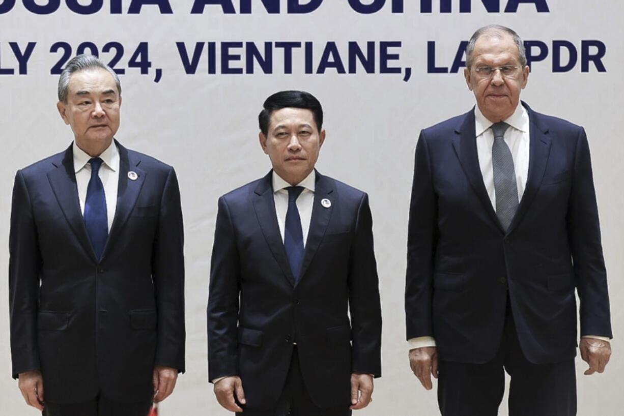 In this photo released by Russian Foreign Ministry Press Service, Chinese Foreign Minister Wang, left, Laos&rsquo; Foreign Minister Saleumxay Kommasith, center, and Russian Foreign Minister Sergey Lavrov pose for a photo on the sidelines of the Association of Southeast Asian Nations (ASEAN) Foreign Ministers meeting in Vientiane, Laos, Thursday, July 25, 2024.