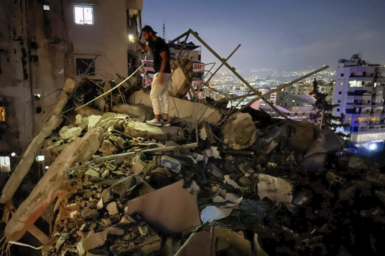 A man inspects a destroyed building that was hit by an Israeli airstrike in the southern suburbs of Beirut, Lebanon, Tuesday, July 30, 2024. An Israeli airstrike hit Hezbollah&rsquo;s stronghold south of Beirut Tuesday evening causing damage, a Hezbollah official and the group&rsquo;s TV station said.