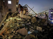 A man inspects a destroyed building that was hit by an Israeli airstrike in the southern suburbs of Beirut, Lebanon, Tuesday, July 30, 2024. An Israeli airstrike hit Hezbollah&rsquo;s stronghold south of Beirut Tuesday evening causing damage, a Hezbollah official and the group&rsquo;s TV station said.